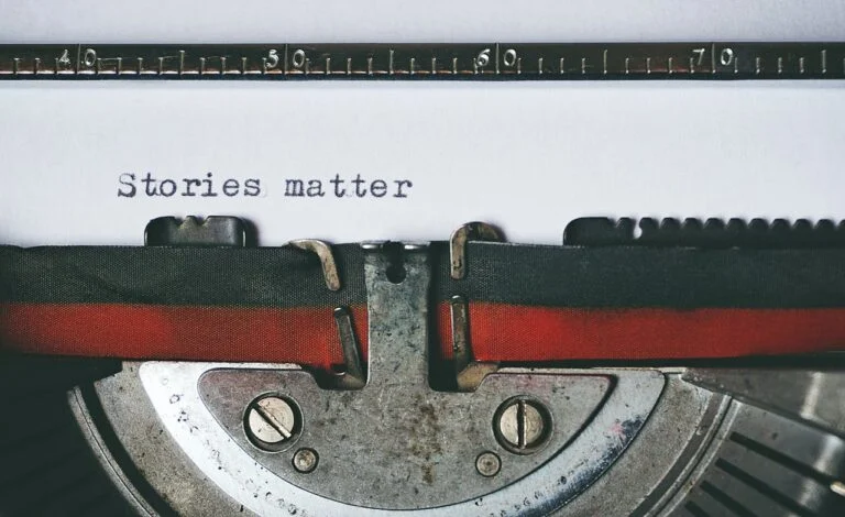 Vintage typewriter with a page reading Stories matter