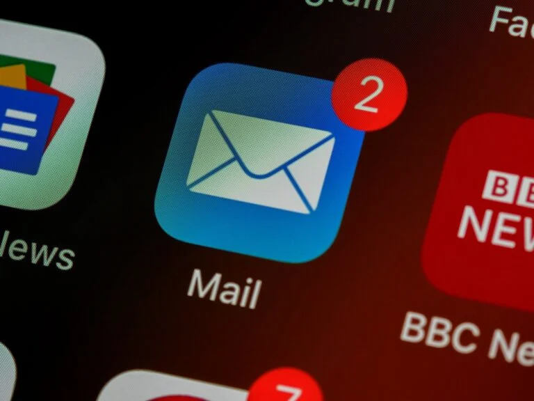 Close-up of a phone home screen with the Mail icon showing two unread messages