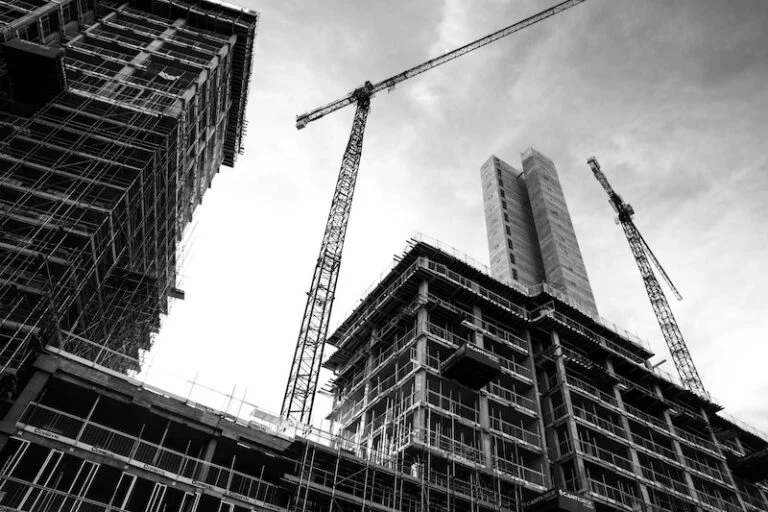 High-rise under construction with tower cranes, in black and white