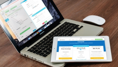 A laptop and tablet showing a custom WordPress pricing comparison screen